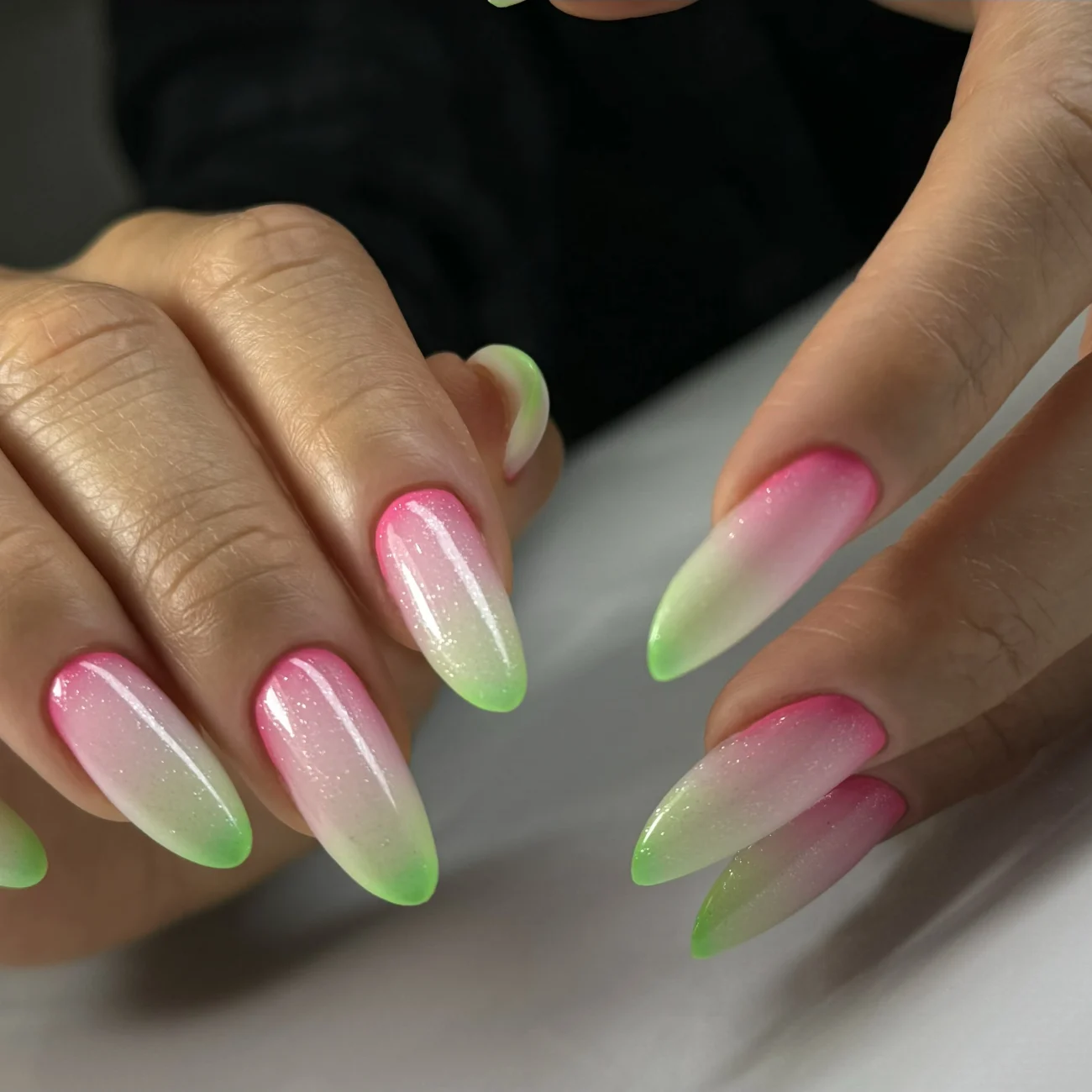 Almond-shaped nails with a bronze shimmering finish.