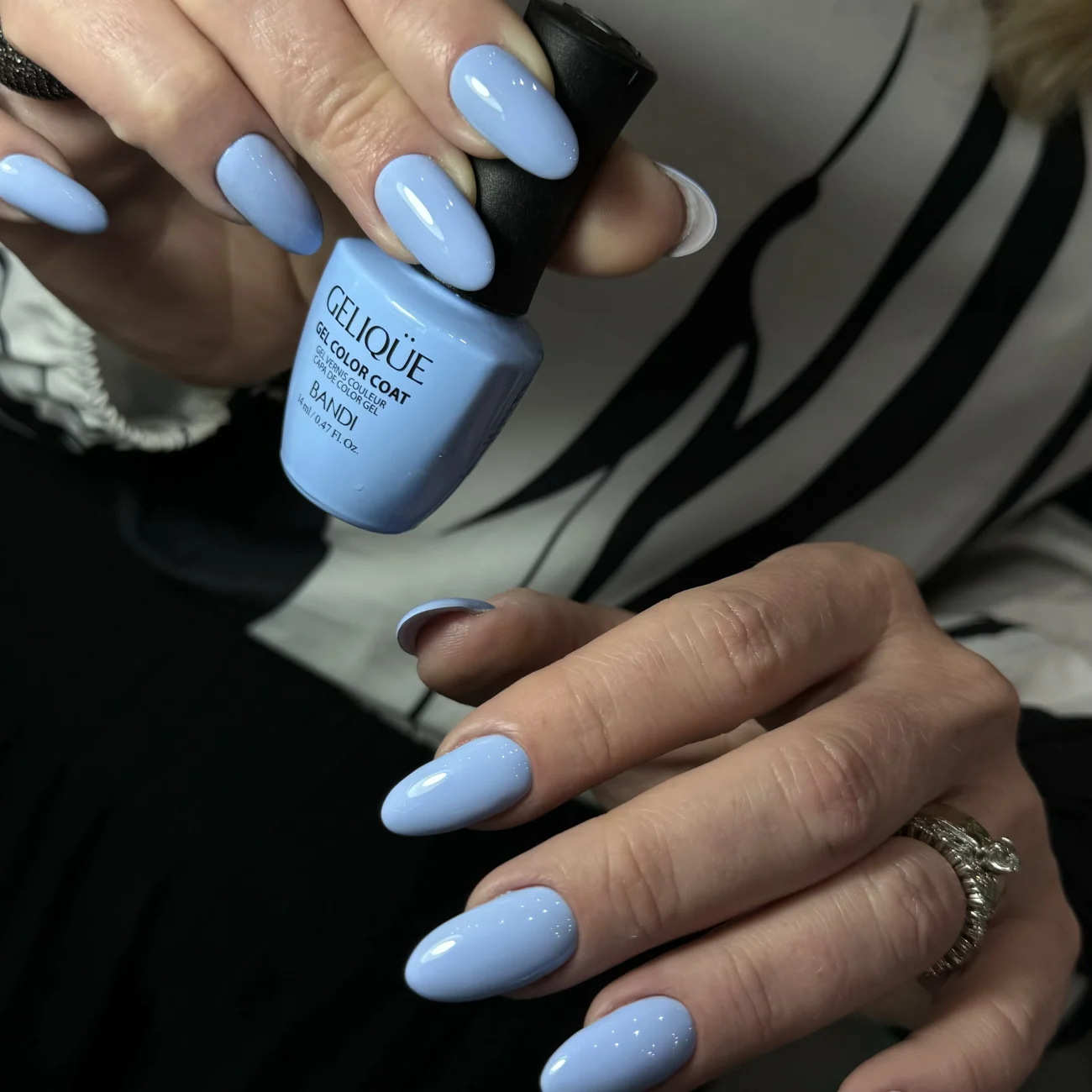 Blue and white gradient nails with a glossy finish, almond-shaped.