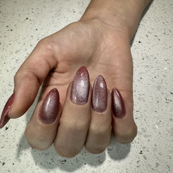 Almond-shaped nails with a bronze shimmering finish.