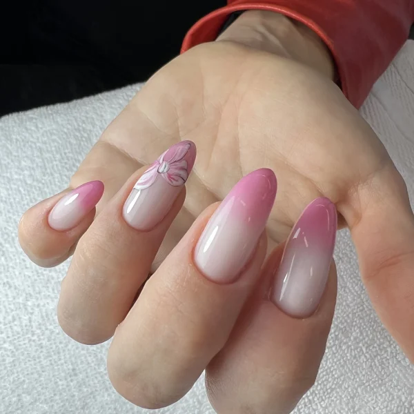 Almond-shaped nails with a soft pink gradient and glossy finish.