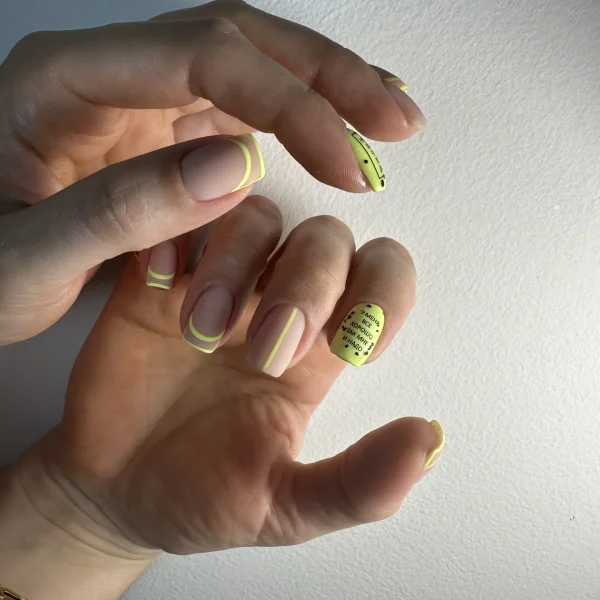 Almond-shaped nails with yellow and green tips and a natural base.