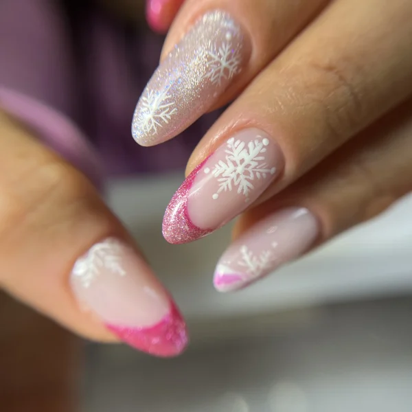 Almond-shaped pink nails with a glittery ombre design.