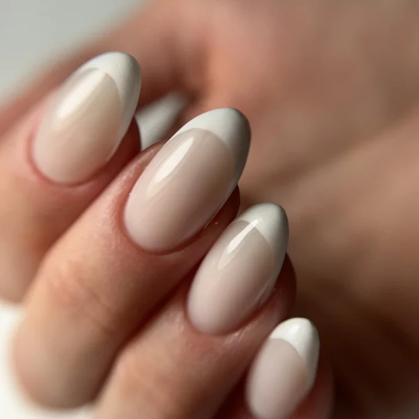 Nude almond-shaped nails with a soft matte finish.