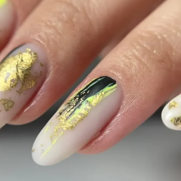 Almond-shaped nails with a yellow and black abstract design.