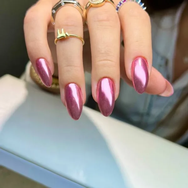 Almond-shaped nails with a metallic pink finish.