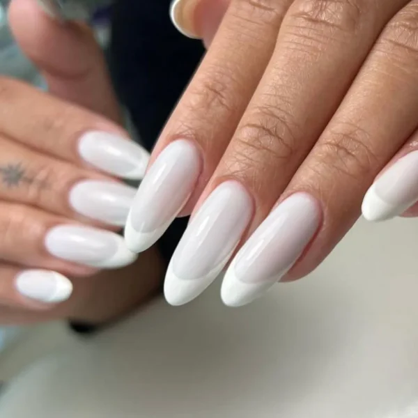 Almond-shaped nails in solid white with a glossy finish.